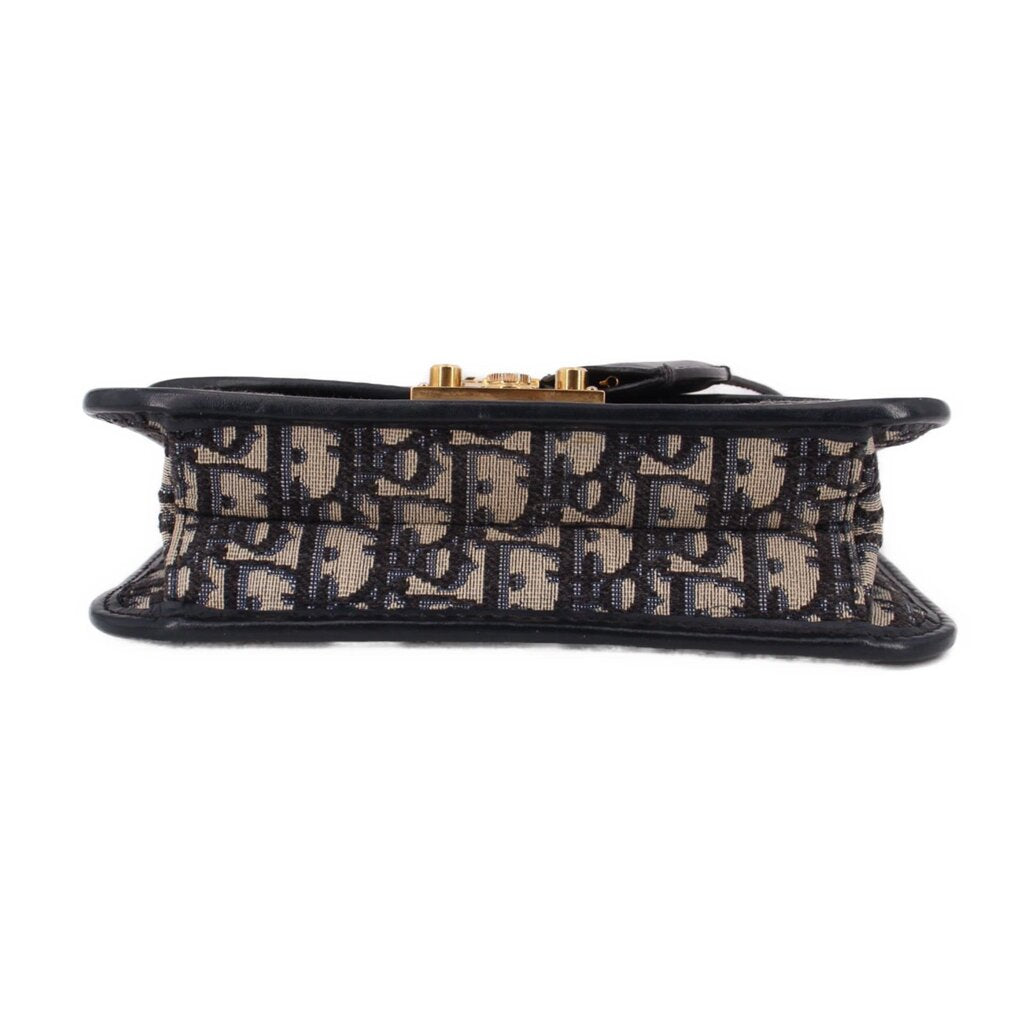 Blue Dior monogram crossbody bag underside with black trim and gold hardware