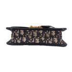 Blue Dior monogram crossbody bag underside with black trim and gold hardware