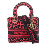 Pink and black leopard-print mini tote with top handles, logo strap, and gold hardware