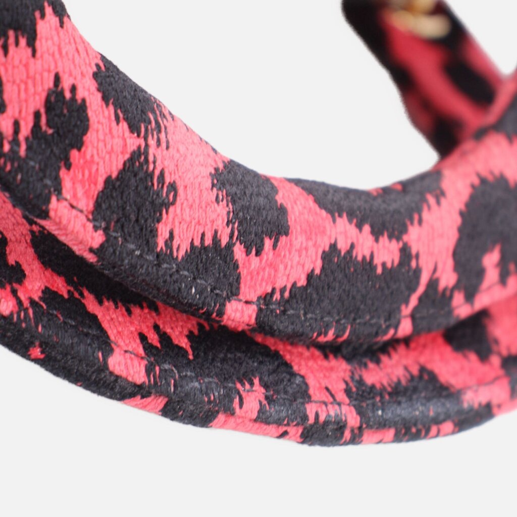 Leopard-print canvas shoulder strap attachment with pink-and-black woven texture