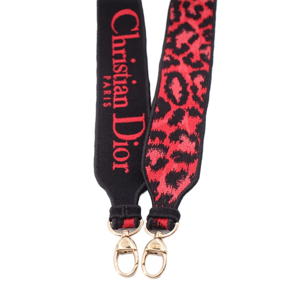 Adjustable strap ends with metal rings; leopard-print panel and Dior Paris lettering