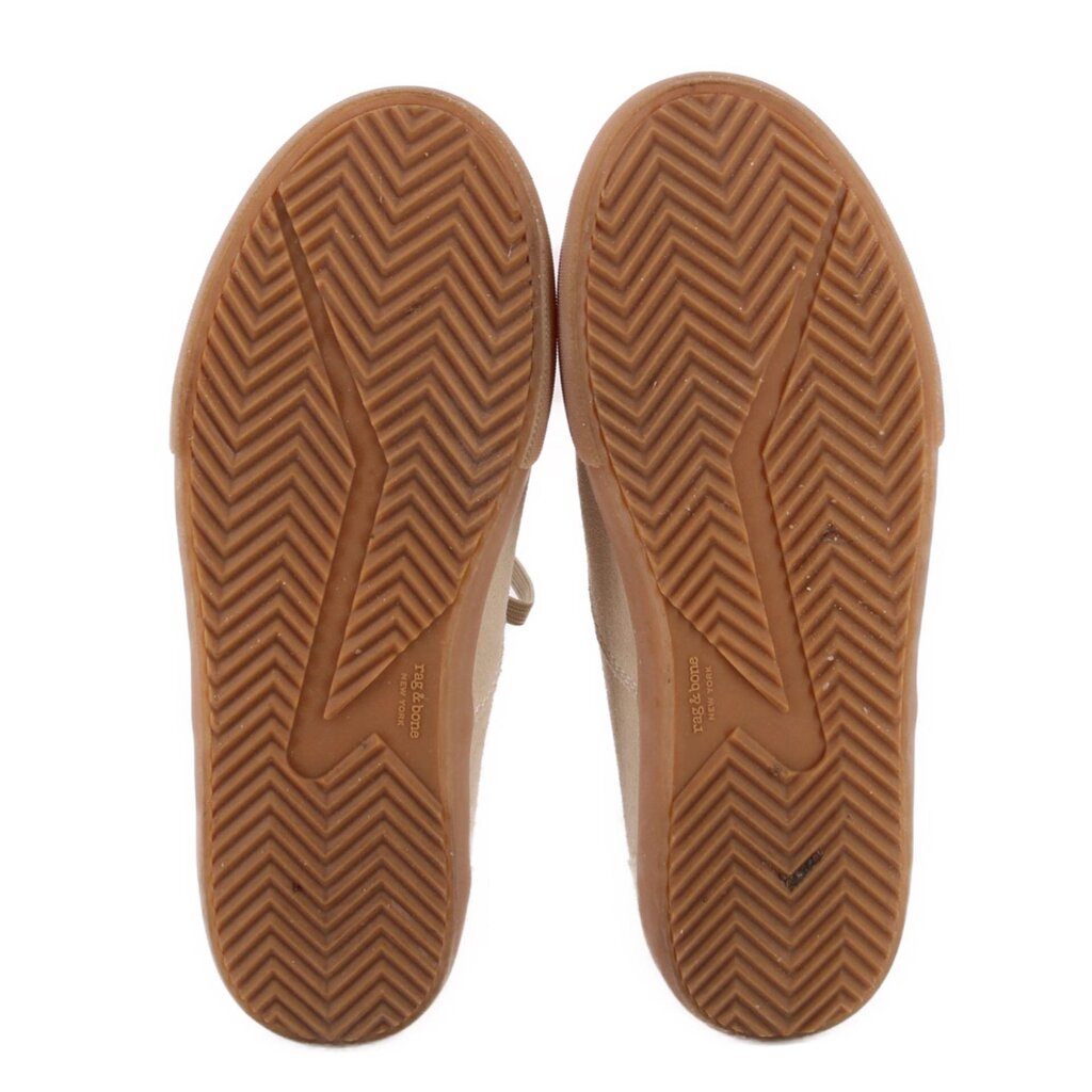 Beige suede sneaker outsoles with chevron tread and durable gum rubber