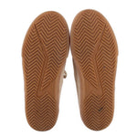 Beige suede sneaker outsoles with chevron tread and durable gum rubber