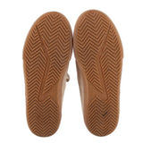 Beige suede sneaker outsoles with chevron tread and durable gum rubber