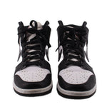 Pair of black and white high-top sneakers with perforated toe and lace-up