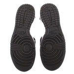 Black rubber outsole with textured tread and circular traction pattern