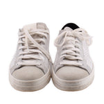 Pair of white leather sneakers with gray suede toe and lace-up ties