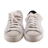 Pair of white leather sneakers with gray suede toe and lace-up ties