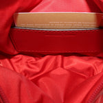 Red fabric-lined interior with stitched label and zip-top opening
