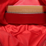Red fabric-lined interior with stitched label and zip-top opening