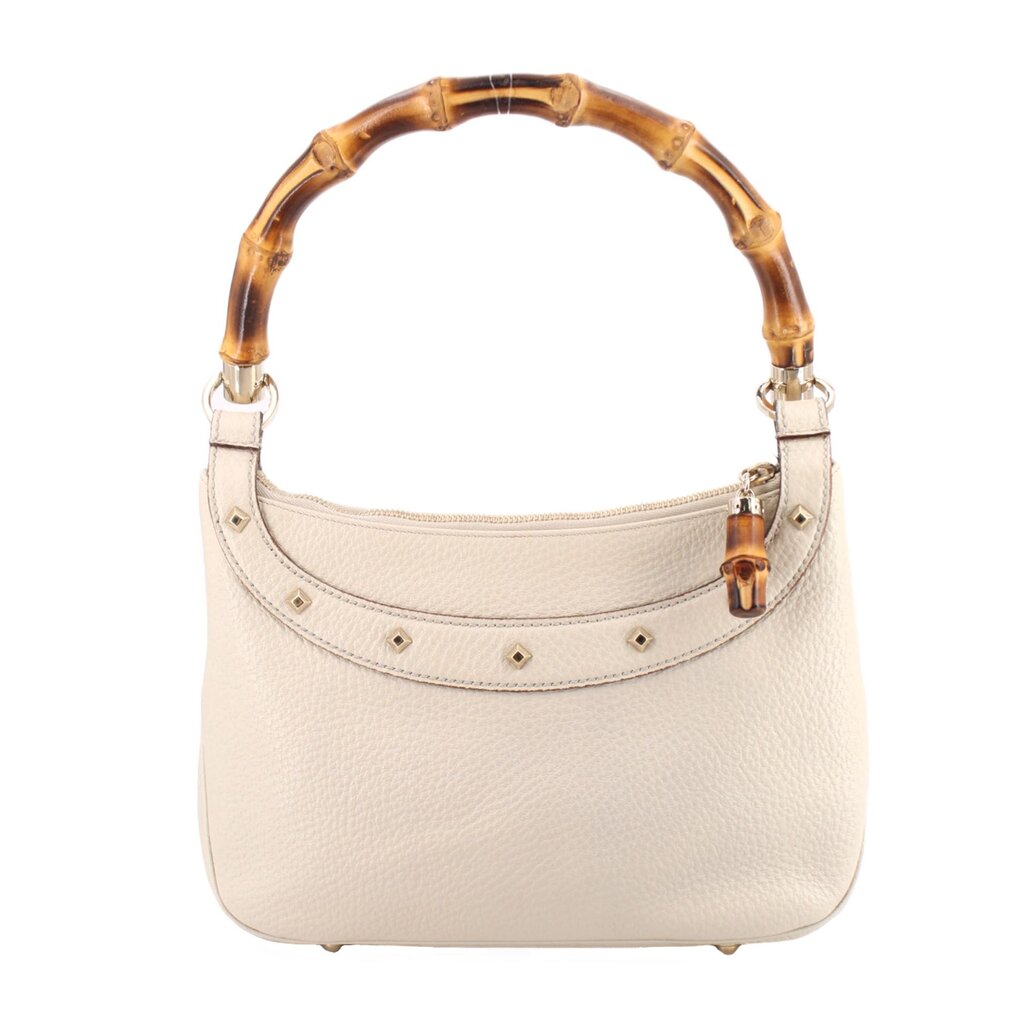 Cream bamboo shoulder bag with pebbled leather and studded trim along the top edge