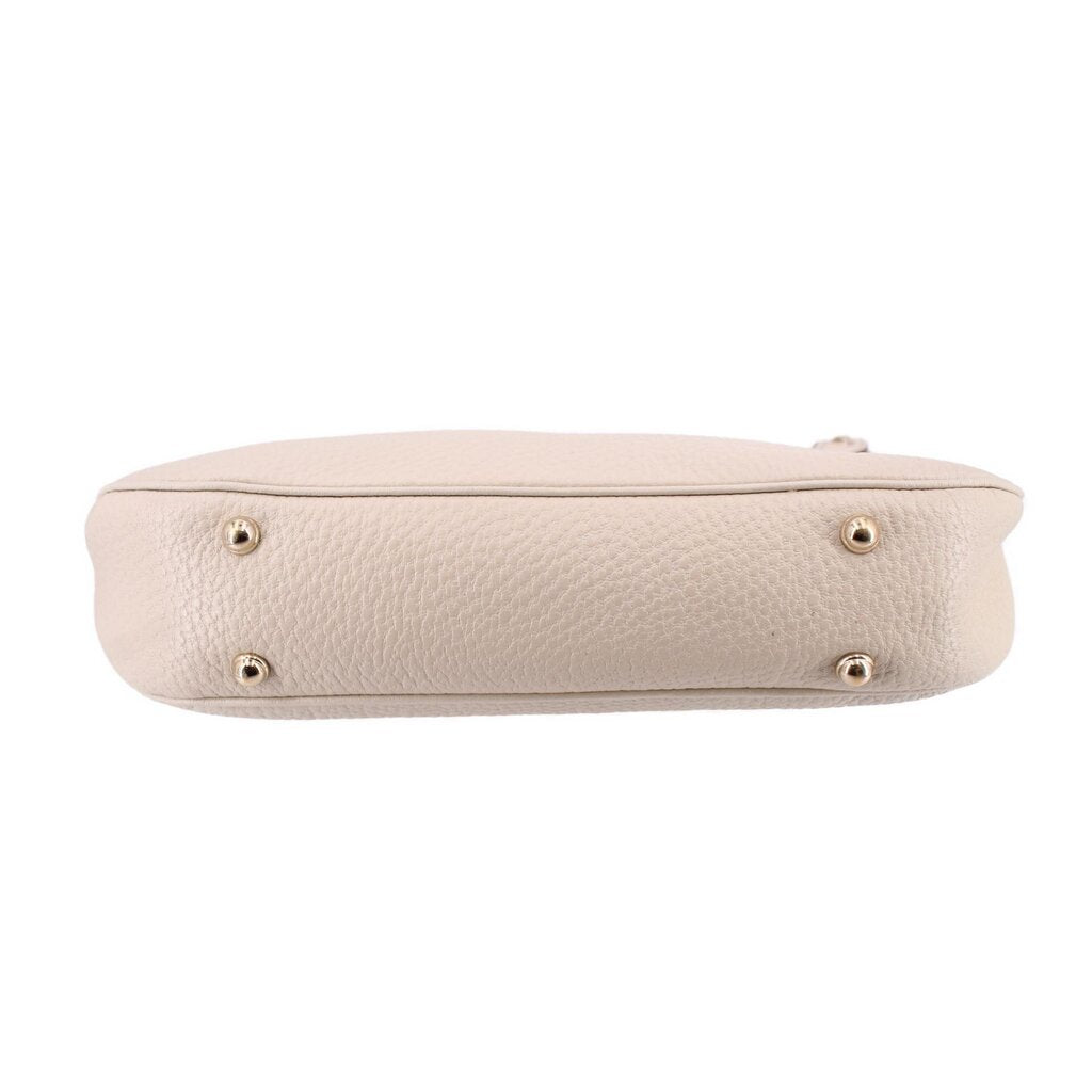 Cream bamboo shoulder bag bottom view with four gold-tone feet