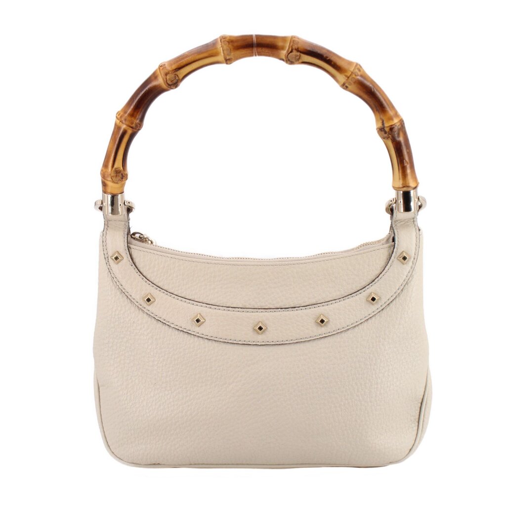 Cream bamboo shoulder bag front view with studded decorative band on the hobo top