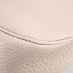 Cream pebbled leather close-up of rounded corner and stitched edge