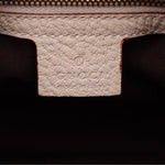Cream interior label area with embossed Gucci logo on leather tab