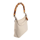 Cream bamboo shoulder bag, side view with curved handle and small metal hardware