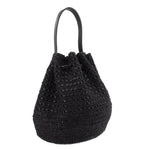 Black raffia bucket crossbody bag with black leather handles and drawstring