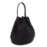 Black raffia bucket crossbody bag with black leather handles and drawstring