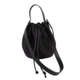 Black raffia crossbody bucket bag with drawstring top and black leather strap