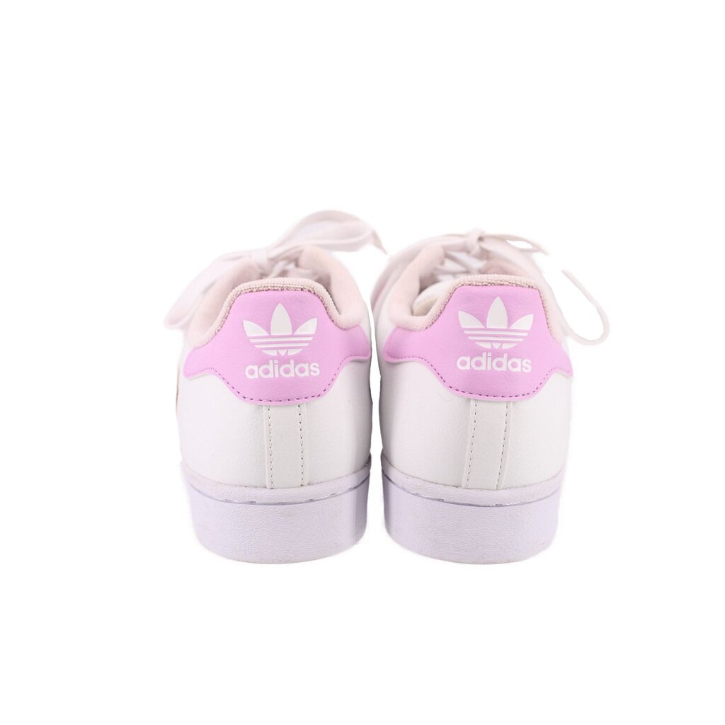 Back view of white sneakers with pink adidas logo on heel tabs