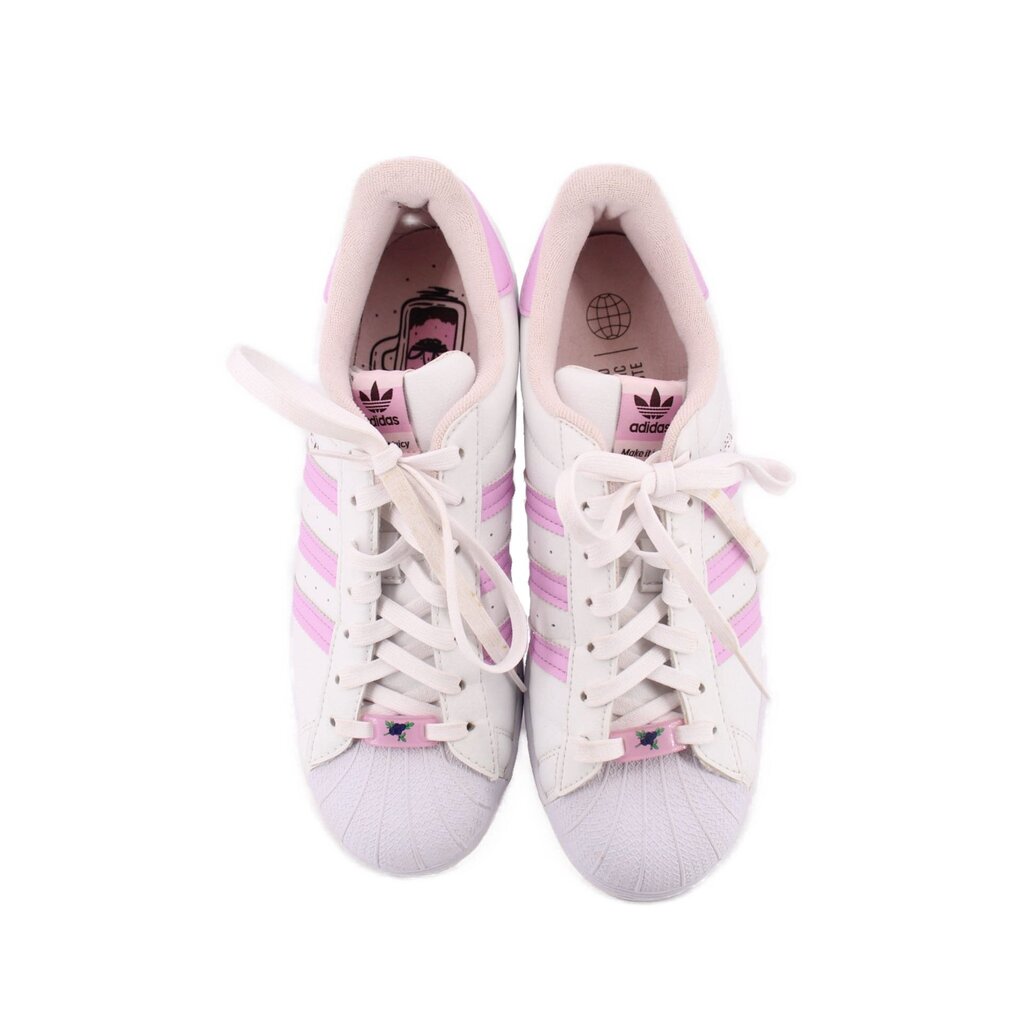 Pair of white lace-up sneakers with pink accents showing tongues and inner lining