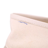 Cream canvas upper with visible side seam stitching and small blue mark