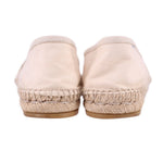 Cream canvas slip-on flats with espadrille jute trim, back view