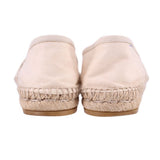 Cream canvas flats with rope-stitched jute trim at heel and textured sole