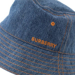 Embroidered BURBERRY on blue denim brim, orange contrast stitching