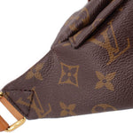 Close-up of monogram bumbag textured leather and brown patterned canvas