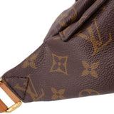 Close-up of monogram bumbag textured leather and brown patterned canvas