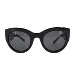 Black cat-eye sunglasses with dark lenses and glossy black frame