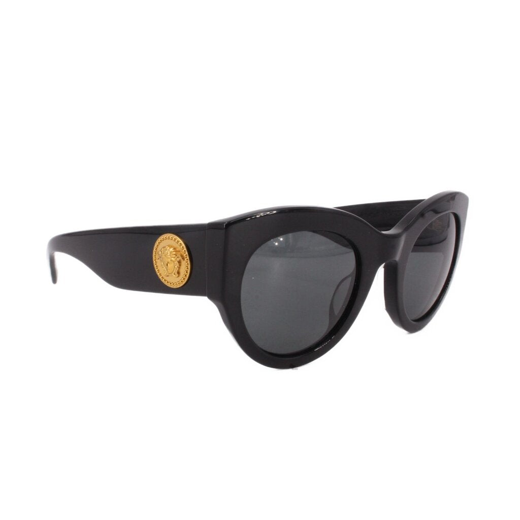Black sunglasses side view with gold logo medallion on temple
