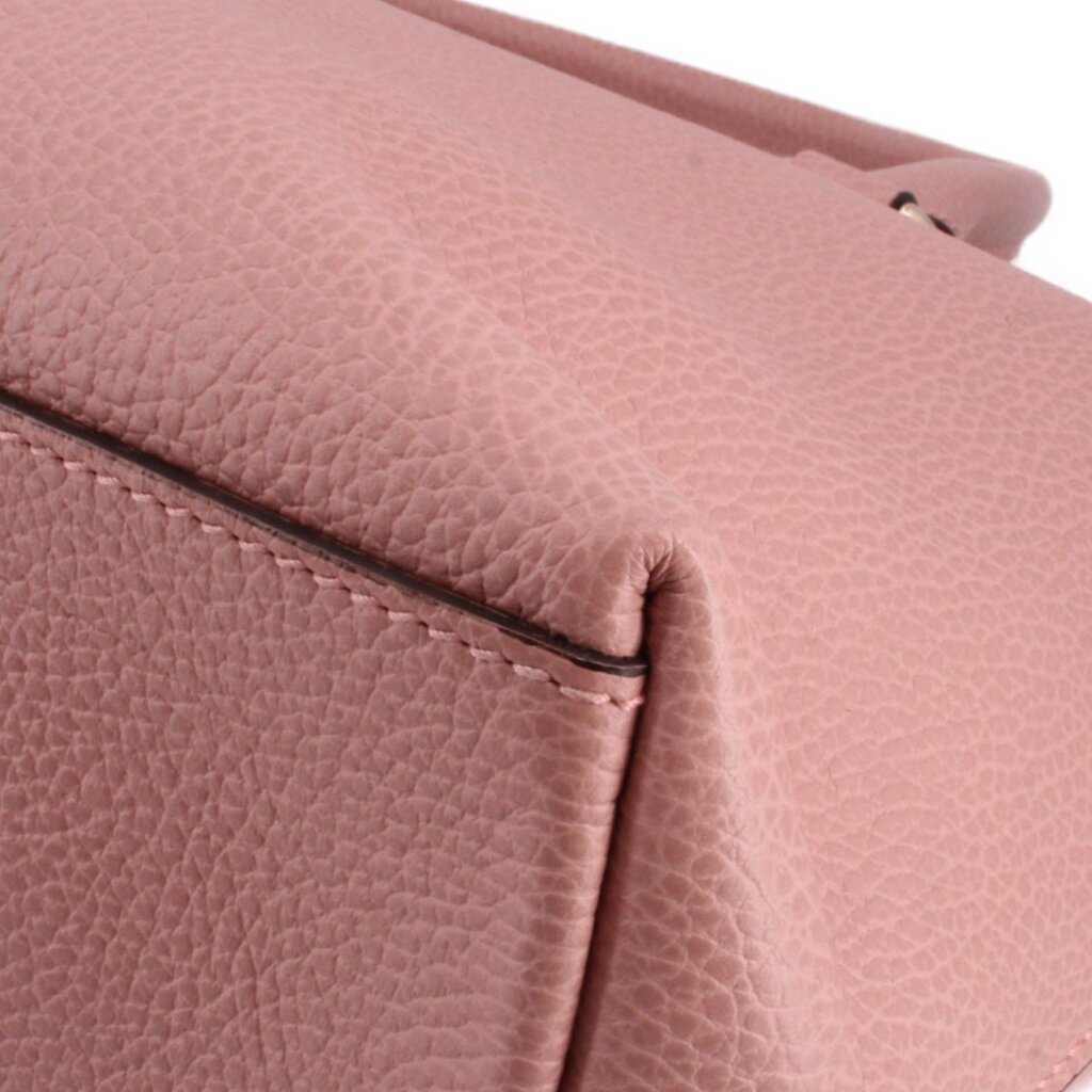 Close-up of blush leather seam and folded corner detail on satchel