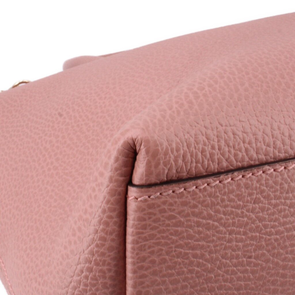 Close-up of blush leather edge with stitching on zip-top satchel