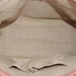 Interior lining view of blush satchel showing fabric lining and stitched edge