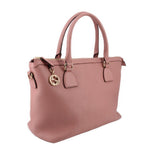 Blush leather satchel with top handles, crossbody strap, and logo emblem