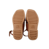 Brown sandal outsoles with textured tread and attached strap detail