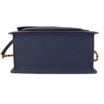 Navy crossbody bag underside view with structured base and flap edge