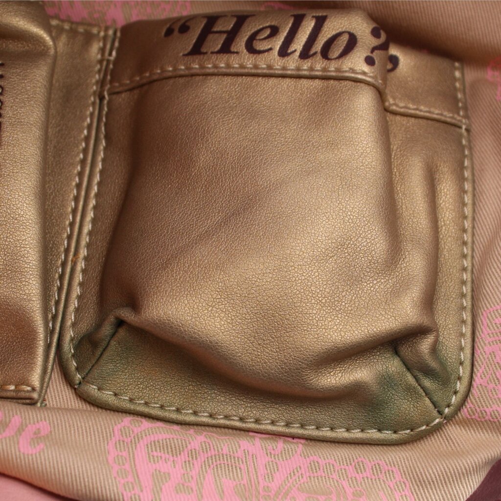 Leather hobo bag front pocket with stitched flap, close-up view