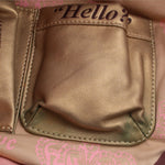 Leather hobo bag front pocket with stitched flap, close-up view