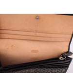 Interior view of black wallet with Coach logo stamp and zip pocket lining