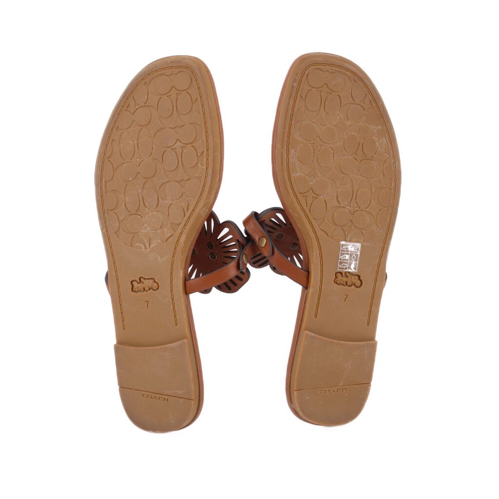Brown thong sandals with textured outsole and embossed branding on footbeds