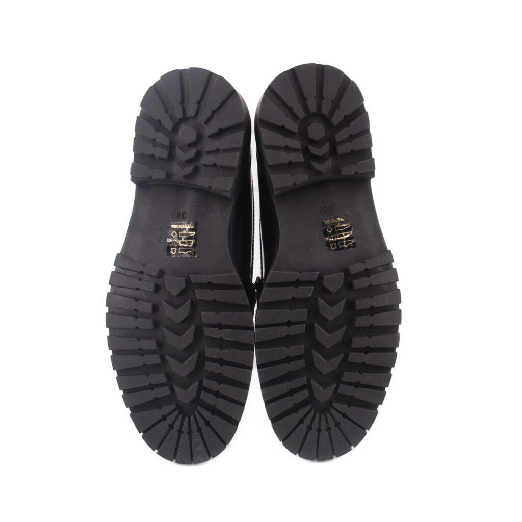 Black loafer outsoles with zigzag tread pattern and MAEVE branding