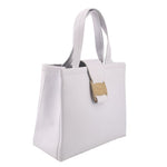 White leather crossbody tote angled view with shoulder strap and top handle