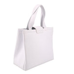 White leather crossbody tote side view with top handle and structured body