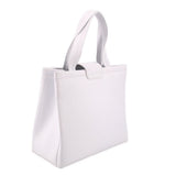 White leather crossbody tote side view with top handle and structured body