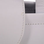 Close-up of stitched seam on white leather crossbody tote corner