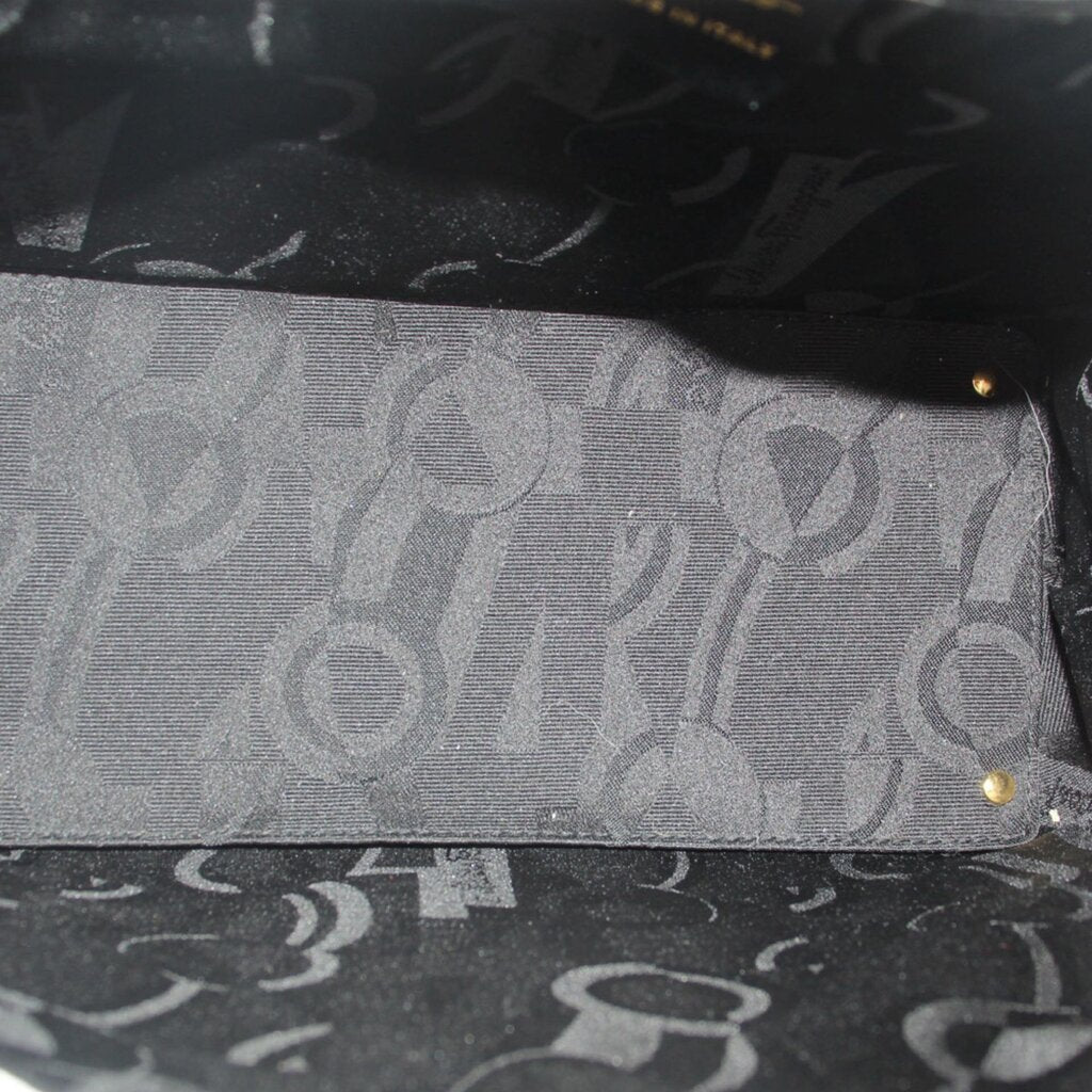 Inside lining of white leather crossbody tote with patterned logo print