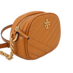 Orange Kira crossbody bag side view with zip top and chain strap, logo on front